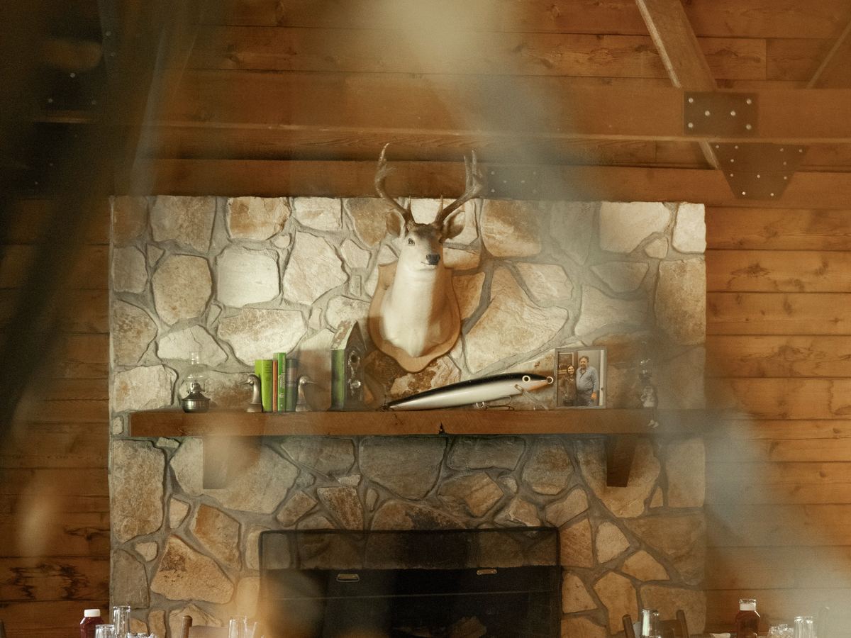The stone fireplace burning in the dining room