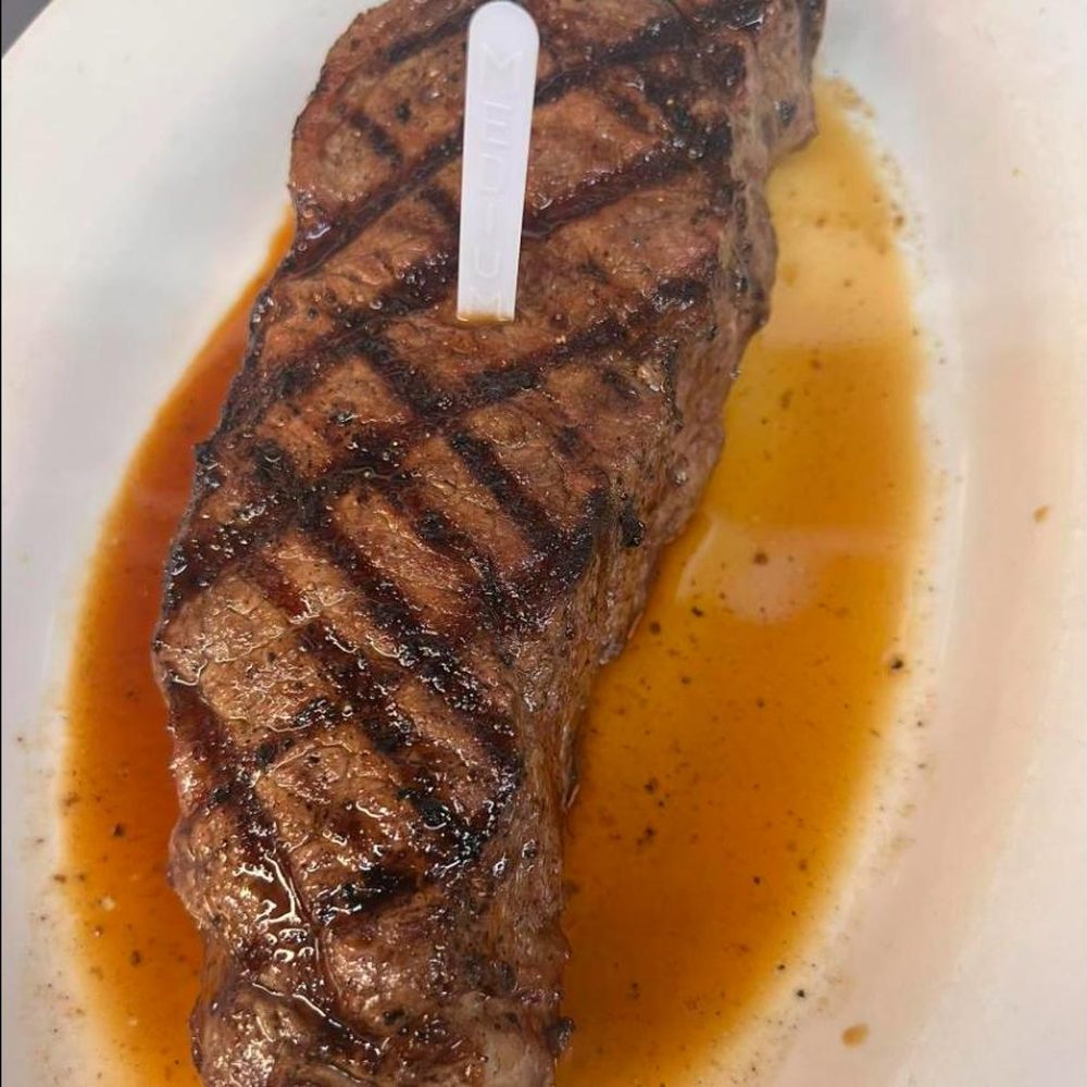 Sliced steak plated with pan juices